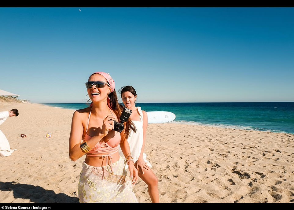 Funny photo bomb: Selena was pictured jokingly sticking out her tongue as Nicola cheerfully paused for a snap while holding a small camera in her hand
