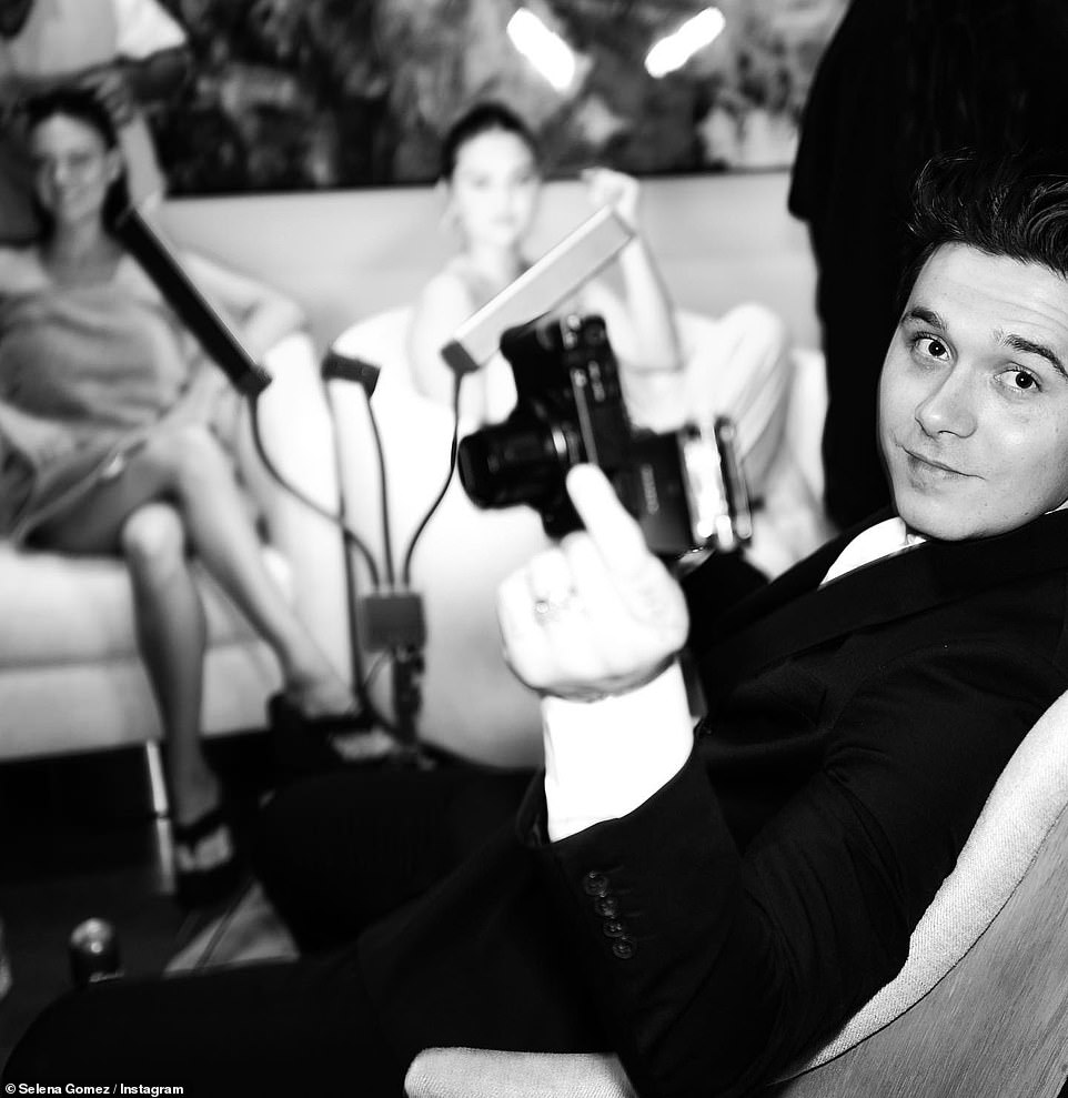 Ready for the festivities: Brooklyn, who didn't spend the Christmas holiday with his family, smiled at the camera as he waited for Selena and his wife to finished getting ready