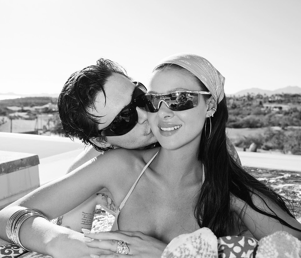 A kiss under the sun: Brooklyn gently kissed his wife's cheek as they enjoyed time in a jacuzzi hot tub with a stunning view behind them
