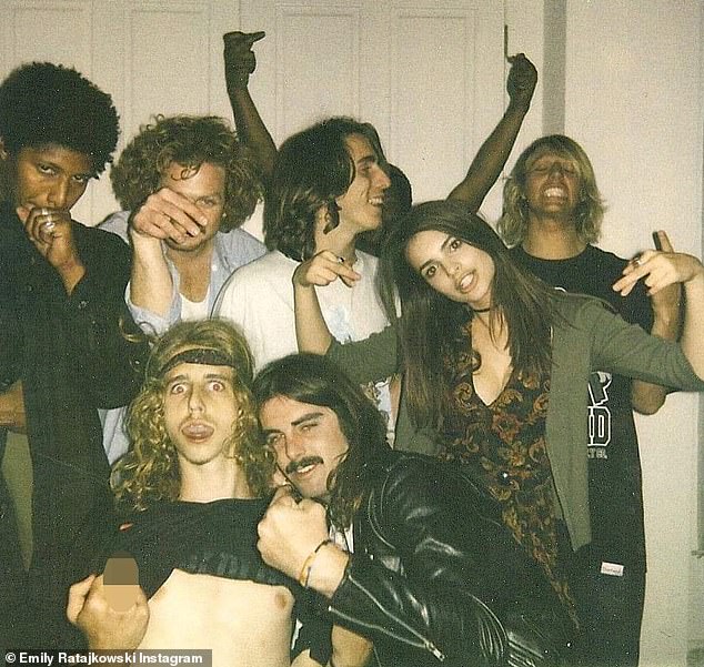 Super cool: The 31-year-old model posted a shot of herself with a group of boys posing who were all posing in various ways