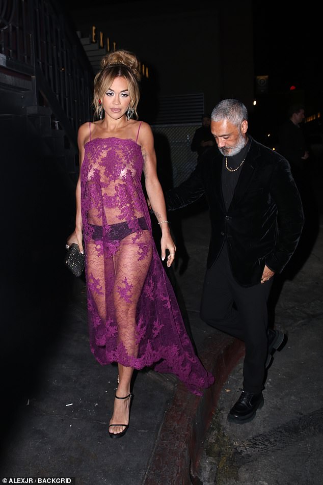 No bra: The 32-year-old singer-songwriter stepped out at the event in a sheer lace dress without a bra underneath it