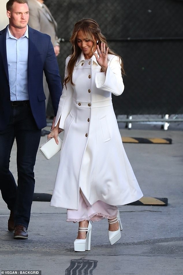 Fan service: She offered a wave to fans in the wings before heading through the stage door