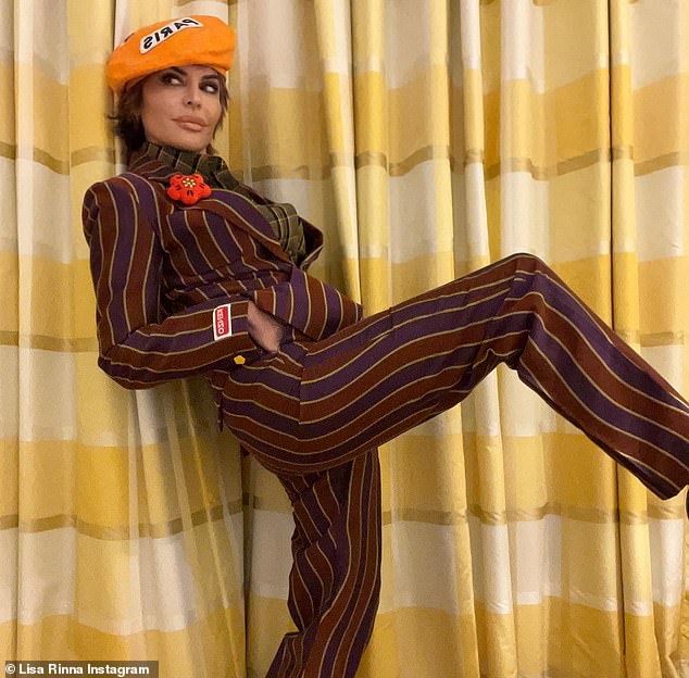 Stripes: Lisa attended the Kenzo Menswear Fall-Winter 2023-2024 show and wore a maroon and purple ensemble with a bright orange beret