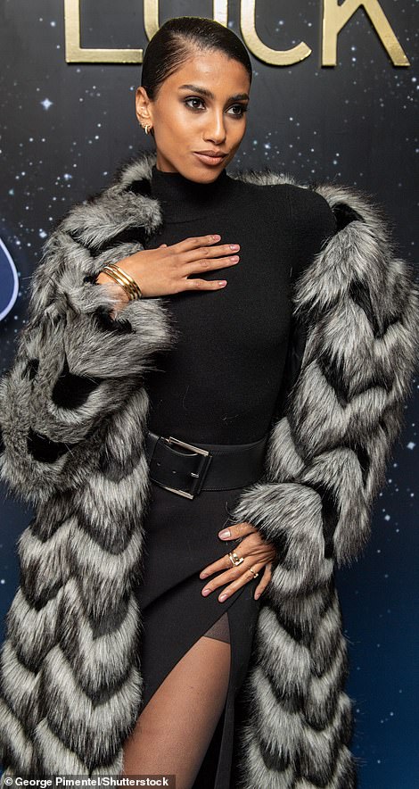 Imaan cinched in her already slender waist with a black belt that had a large buckle