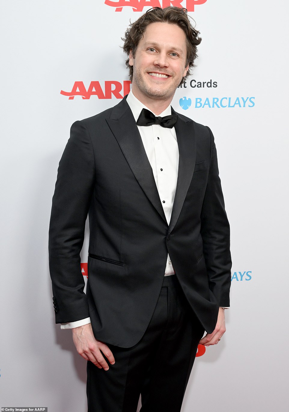 Handsome: Zachary Abel had a big smile on his face as he wore a classic black suit