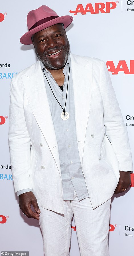Cool: Frankie Faison looked extra cool with a pop of pink to offset his white ensemble