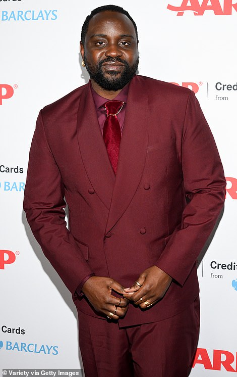 Cuddles: Brian Tyree Henry posed with Jamie on the carpet
