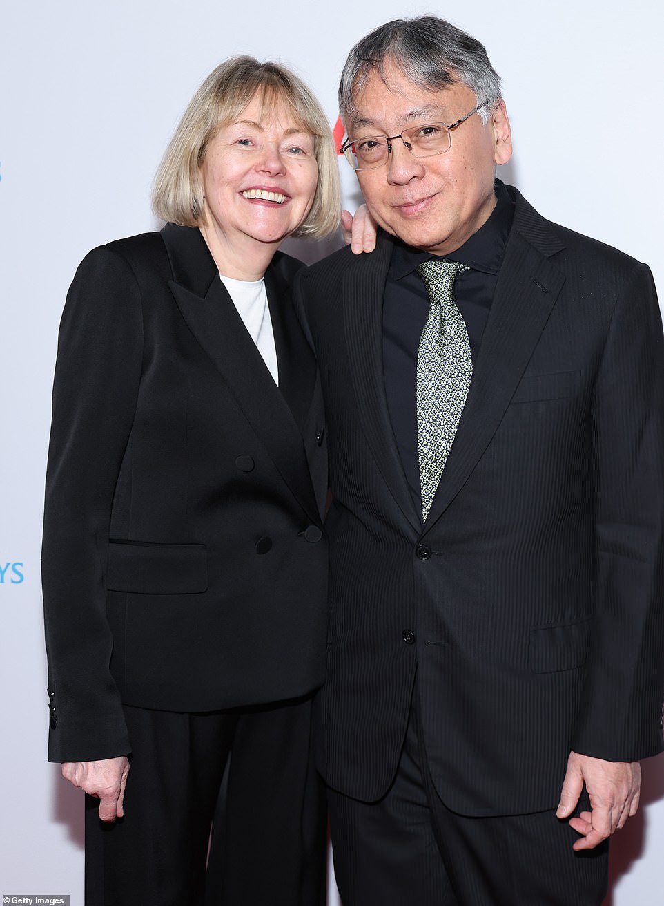 Wholesome: The Ishiguros wore similar black suits as they arrived at the ceremony