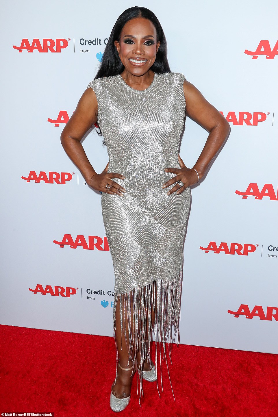 Sheryl paired her gown with silver heels, several rings, a glittering bracelet, and long silver earrings