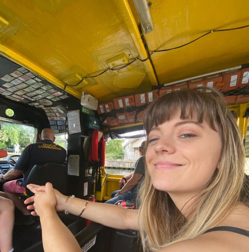 Cyann Fielding inside a duck boat, with the "Duck Commander" driver in the background.