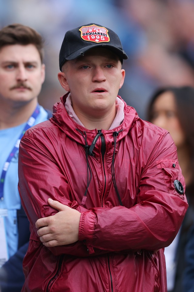 Campbell Hatton reacts as Manchester City supporters unveil a banner dedicated to his father Ricky Hatton.