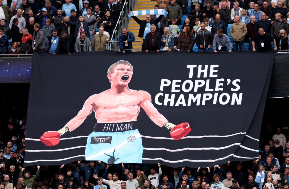 Banner in memory of Ricky Hatton with an illustration of the boxer and the words "THE PEOPLE'S CHAMPION".