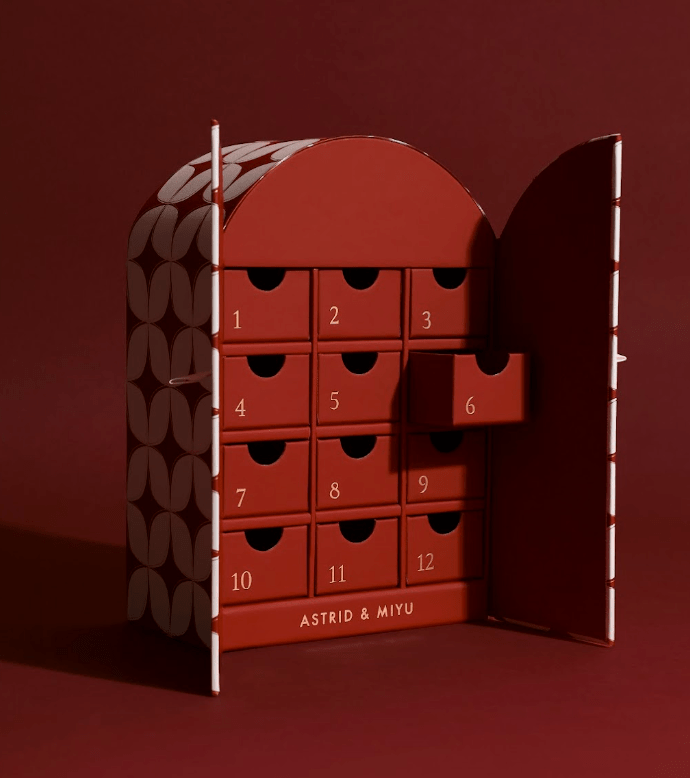 Red advent calendar from Astrid & Miyu with an open door and partially open drawer number 6.