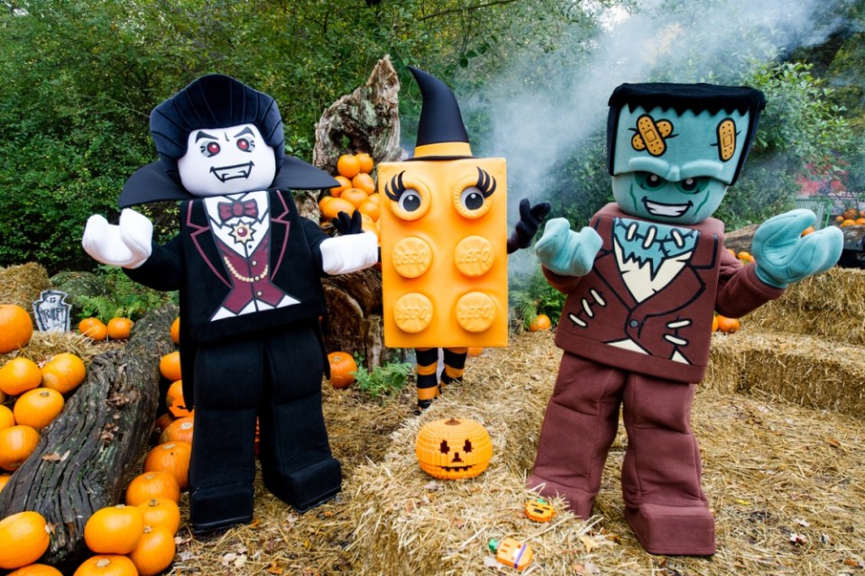 Three LEGO characters dressed as Dracula, a witch, and Frankenstein for Legoland Windsor Resort's Brick or Treat Halloween attraction.