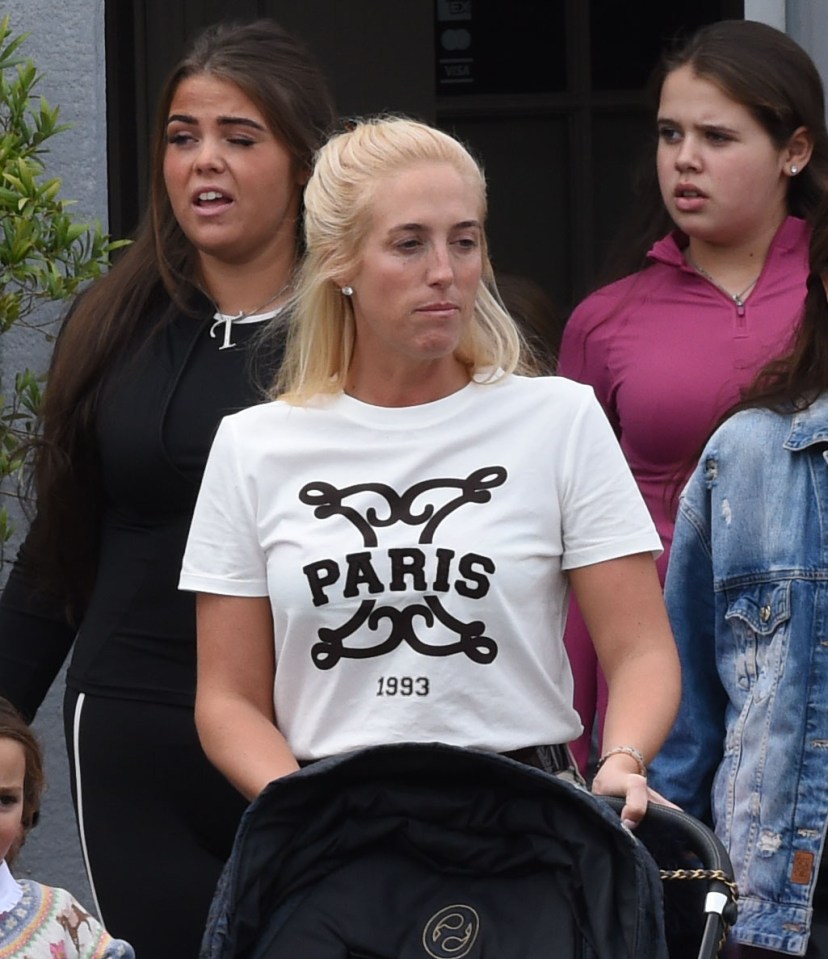 Paris Fury pushing a stroller with other women and children behind her.
