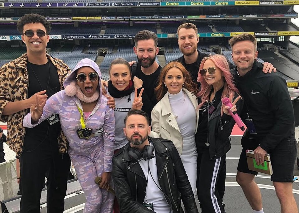The Spice Girls with their choreographer Paul Roberts and other people, showing tribute.