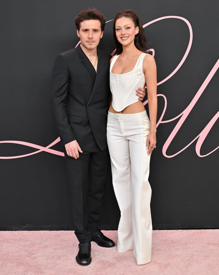 Brooklyn Peltz Beckham in a black suit with Nicola Peltz Beckham in a white sleeveless top and white pants at a premiere.