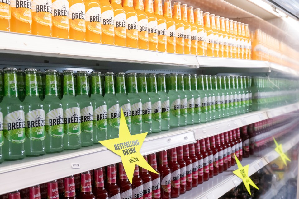 Rows of Breezer bottles on a store shelf; a yellow star indicates a bestselling drink.