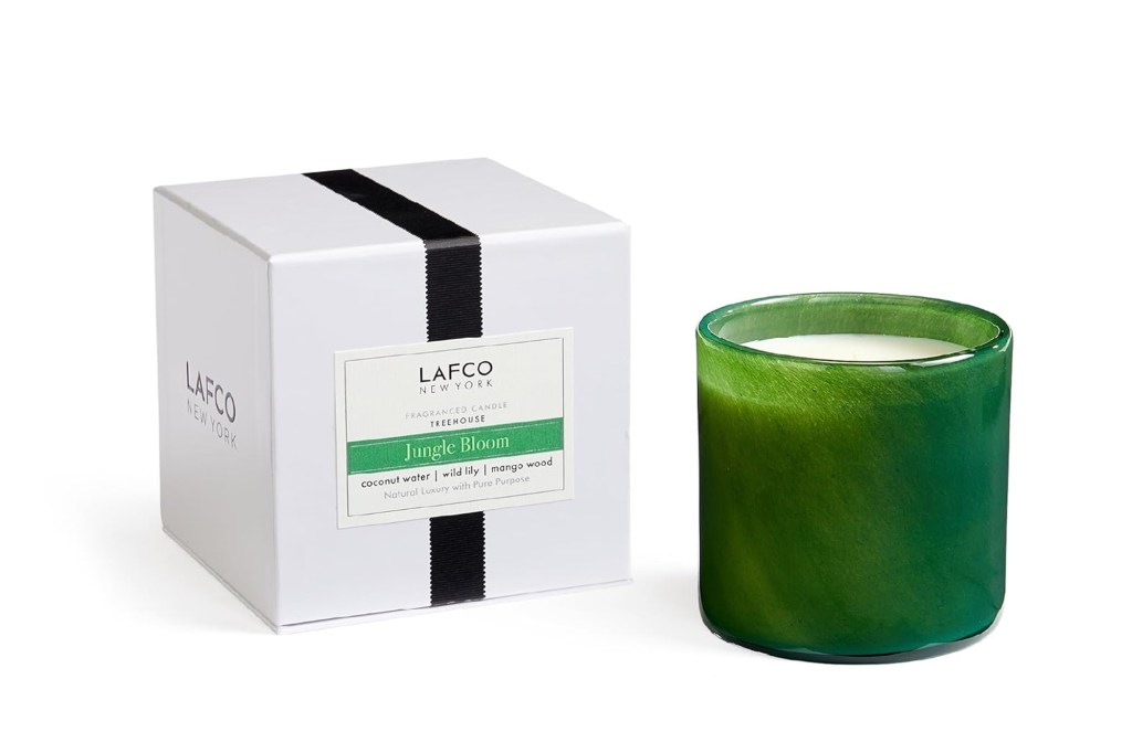 LAFCO New York Treehouse Jungle Bloom candle in a green glass holder, with a white box.