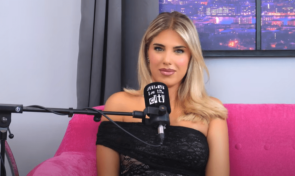 Woman on podcast, speaking into microphone.