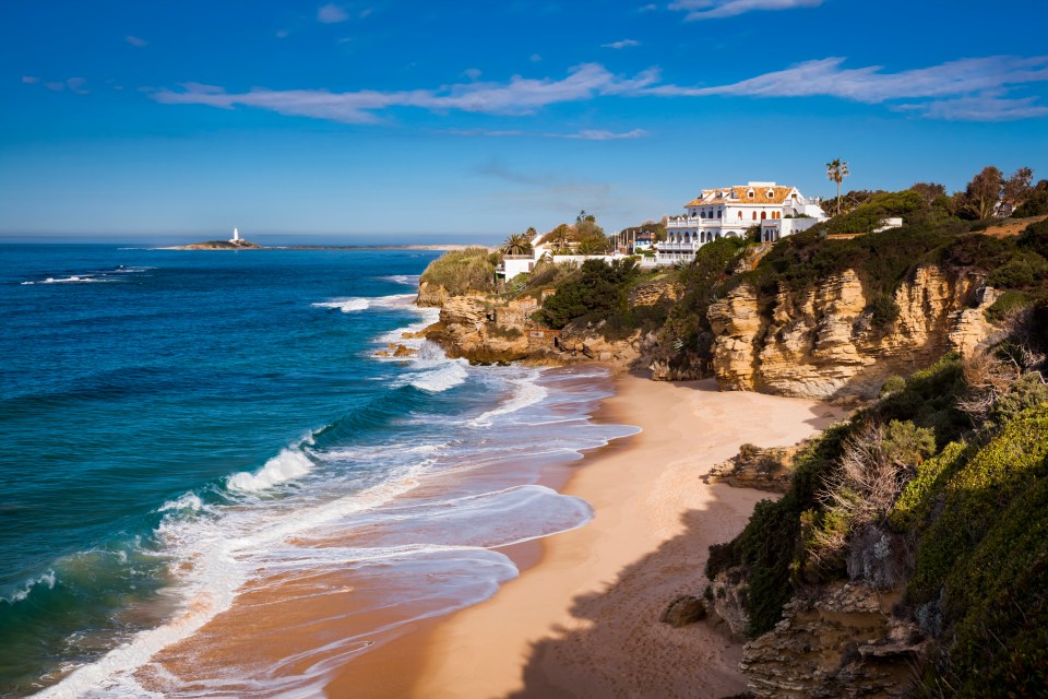Beach at Los Canos de Meca with the Cape Trafalgar lighthouse in the distance.