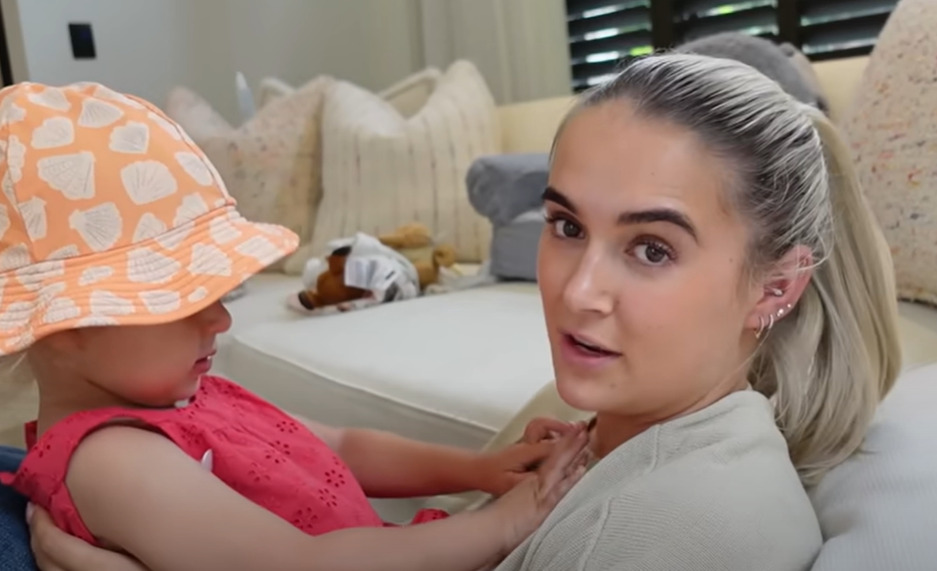 Molly-Mae sitting on a couch with her daughter.