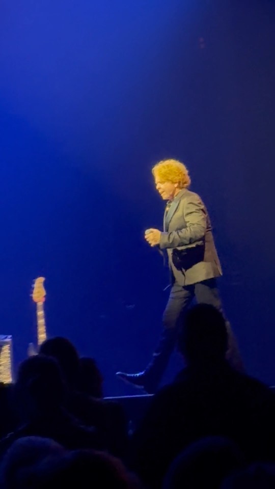 Mick Hucknall of Simply Red on stage during a performance.