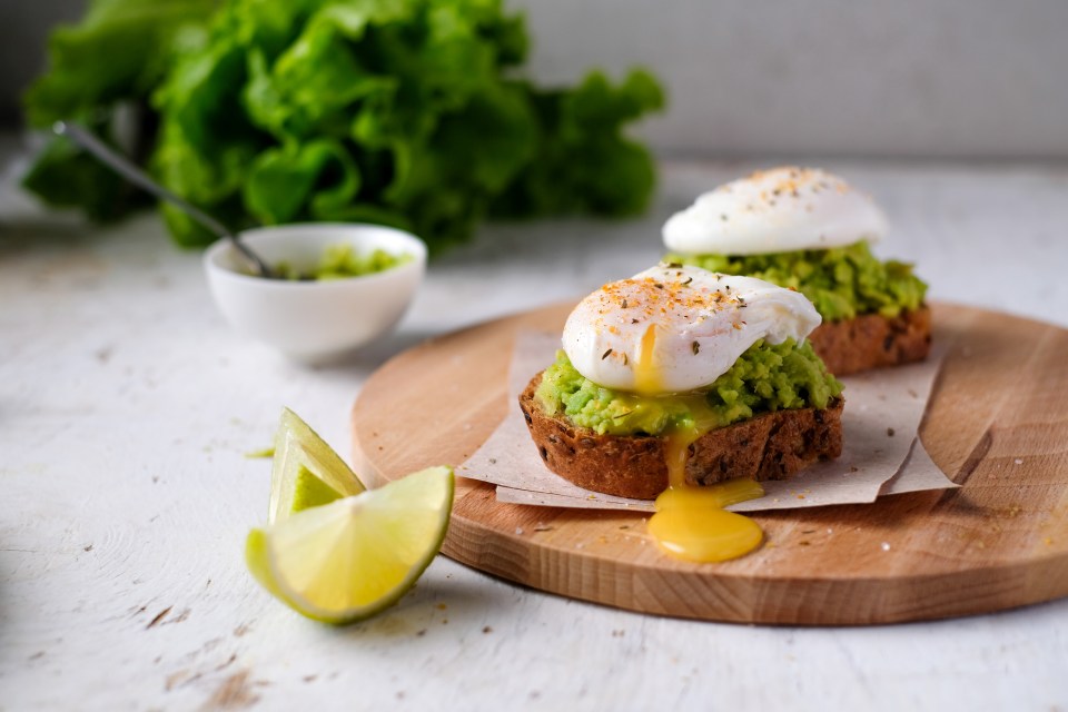 Vegetarian bruschetta with avocado, lime, and poached eggs.