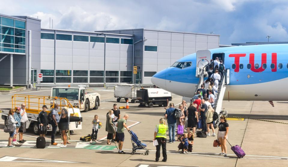 Passengers queuing to board a TUI Boeing 737 at Bristol Airport.
