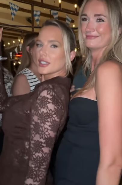 Helen Flanagan in a plunging brown lace jumpsuit, smiling.