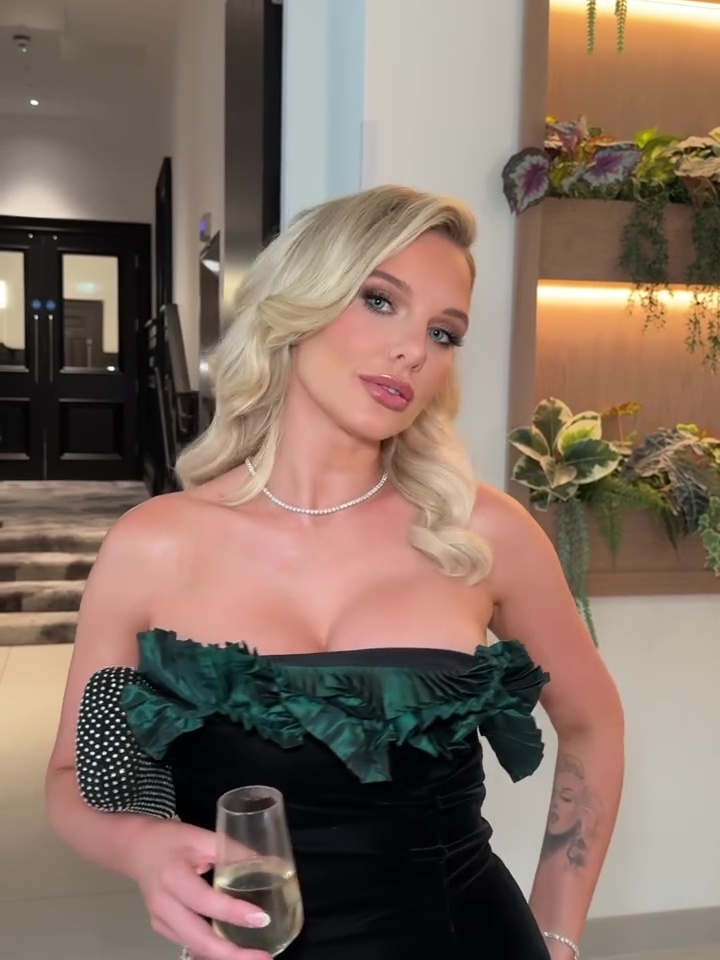 Helen Flanagan in a strapless green dress, holding a glass of champagne.