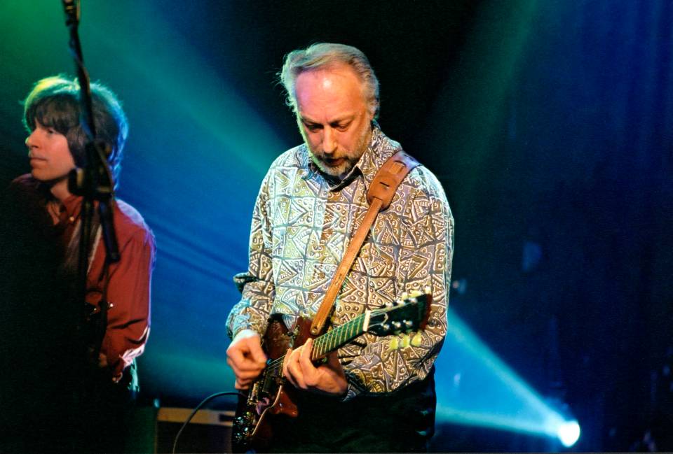 Chris Dreja performing live with his guitar.