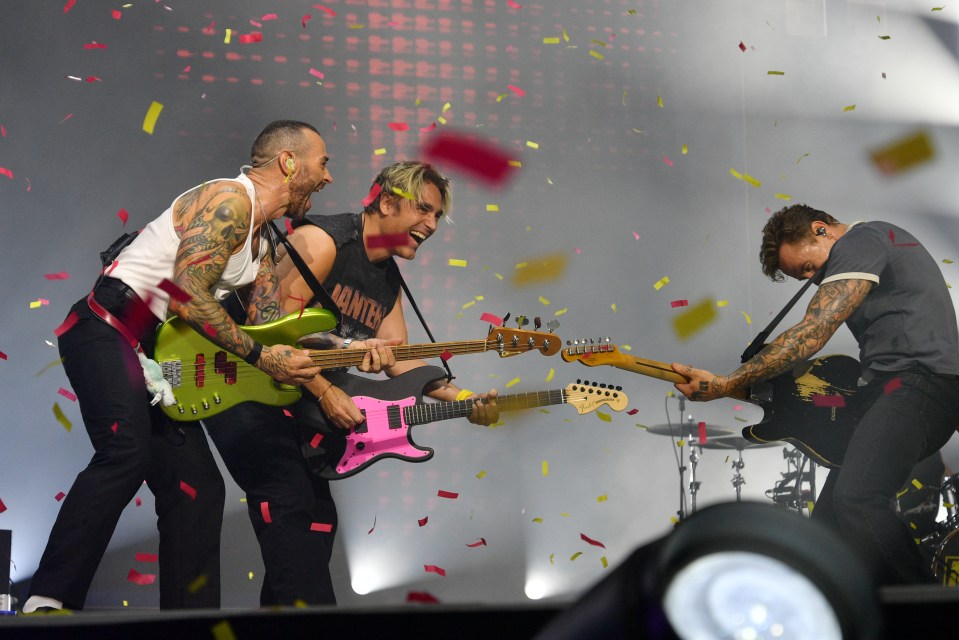 Matt Willis, Charlie Simpson, and Danny Jones of Busted and McFly perform onstage during the Busted vs McFly Tour.