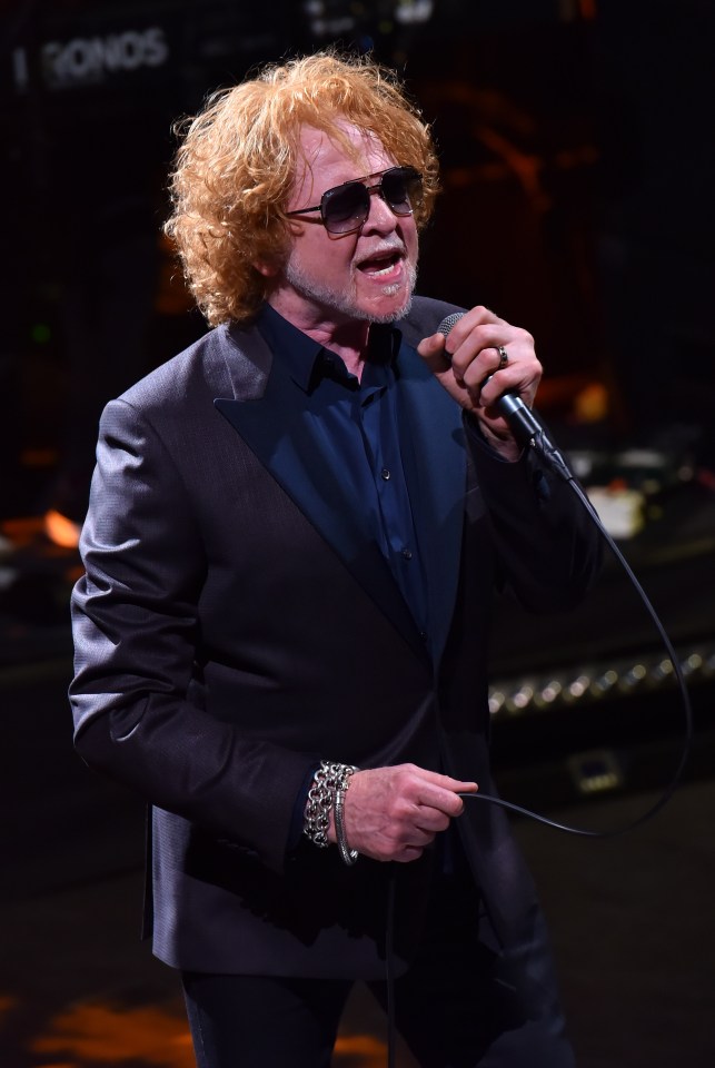 Mick Hucknall of Simply Red performing on stage.