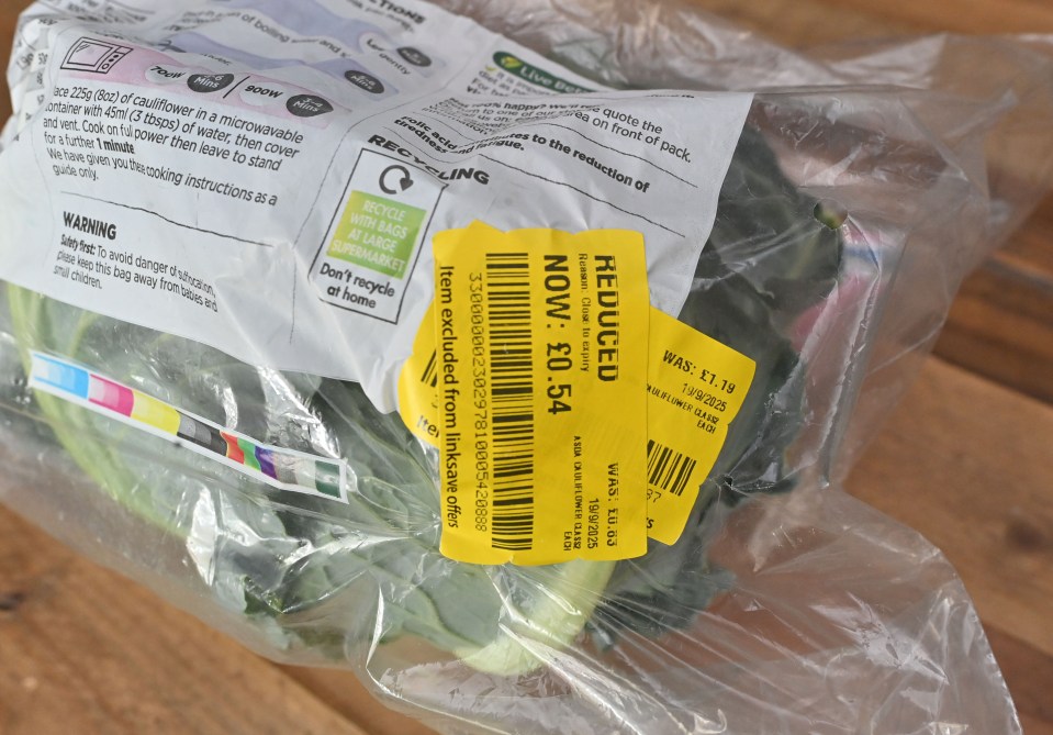 Plastic-wrapped cauliflower with a yellow "REDUCED" sticker showing the price is now 54p, down from £1.19.