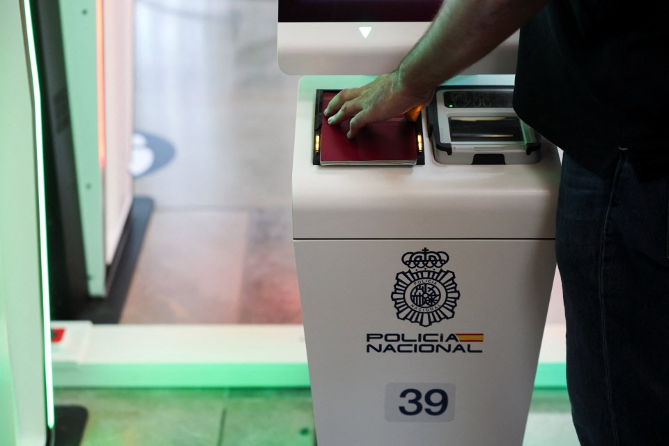 A man demonstrates the Entry/Exit System by placing a passport on a scanner.