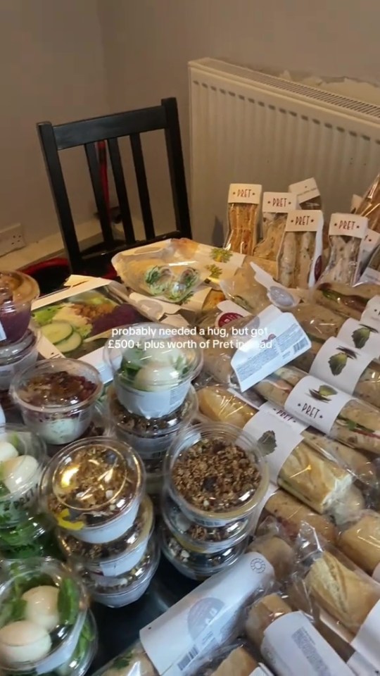 A large collection of Pret A Manger food items, including sandwiches, wraps, salads, and desserts, covering a table.