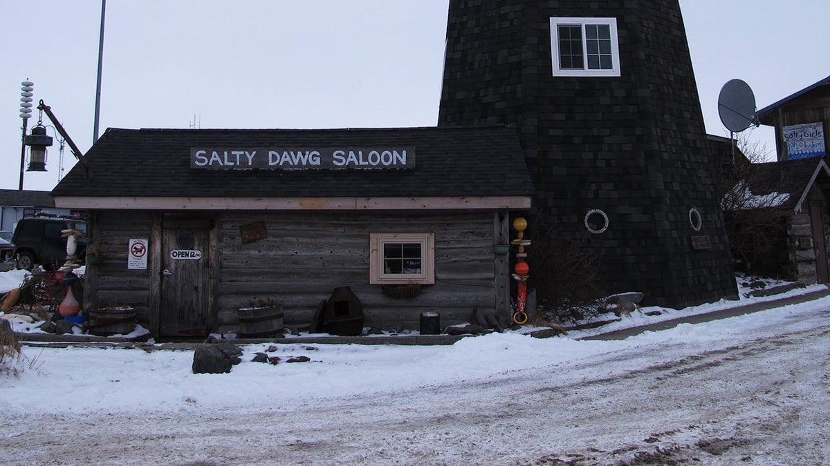 Exterior of Salt Dawg Saloon in Homer, Alaska. Snow seen on ground.