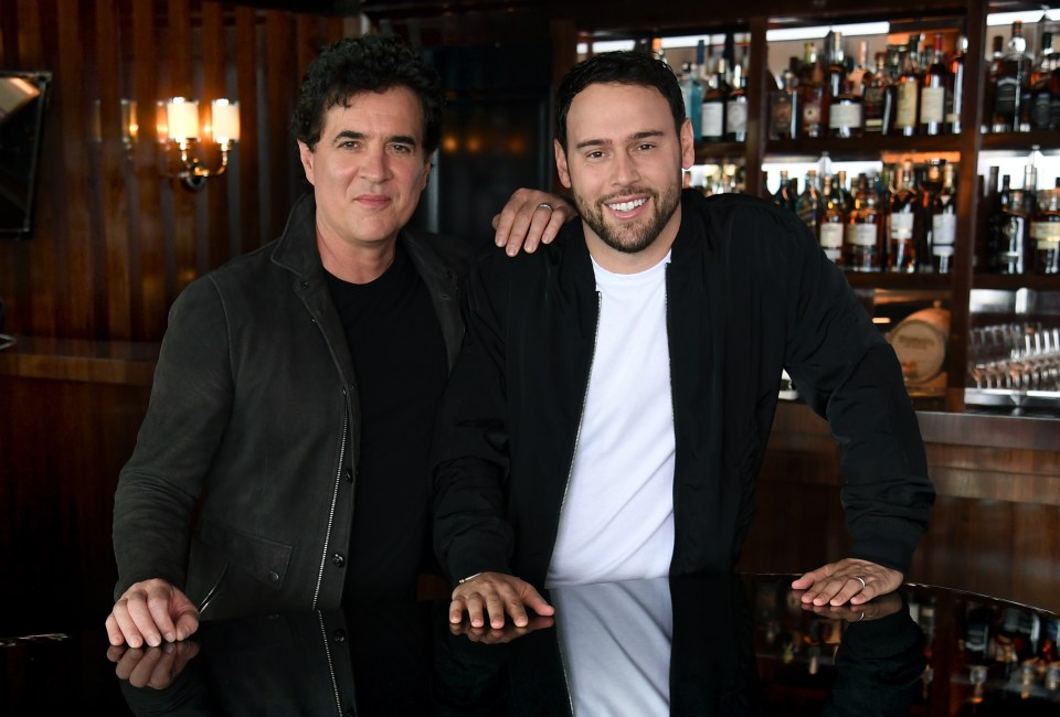Scott Borchetta and Scooter Braun standing at a bar.