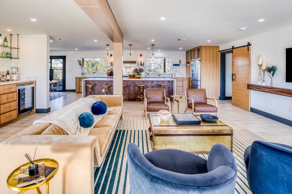 A stylish holiday home with an open-concept living room, kitchen, and dining area.