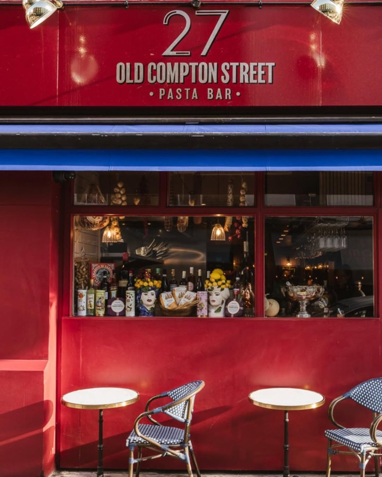 A red storefront with "27 Old Compton Street, Pasta Bar" written above a blue awning.
