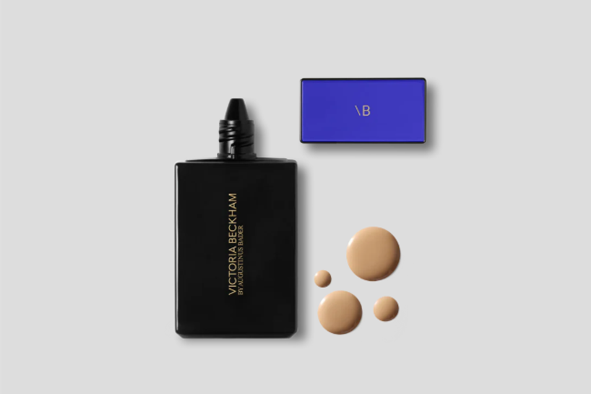 Victoria Beckham by Augustinus Bader foundation bottle with drops of foundation.
