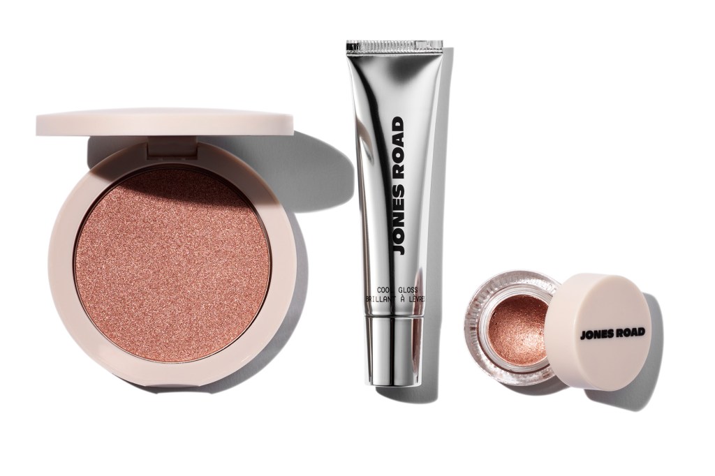 Jones Road makeup products, including a compact, a tube of Cool Gloss, and a pot of shimmer eye shadow.