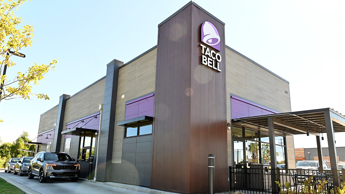 Logo and exterior facades of Taco Bell restaurants in Ohio, USA, photographed on Monday, September 29, 2025. Cars seen lined up at drive-thru.