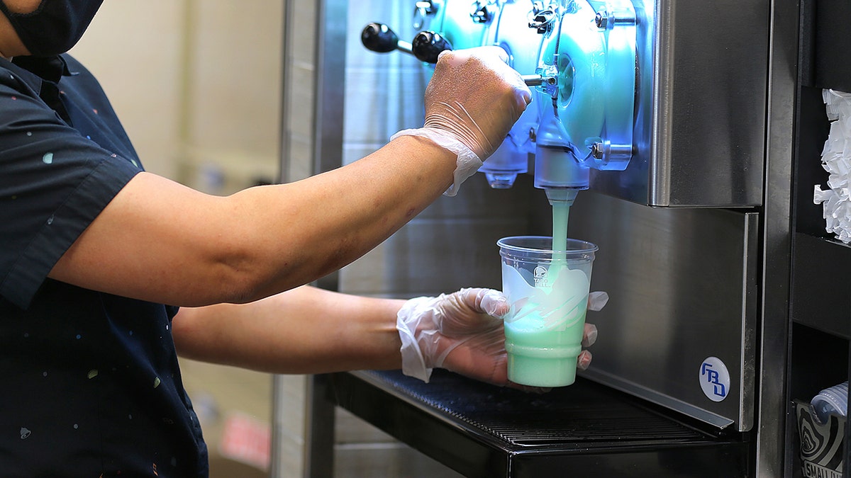 An employee makes the popular Mountain Dew Baja Blast frozen drink from the frozen drink machine at the new Taco Bell Cantina in Brookline, MA