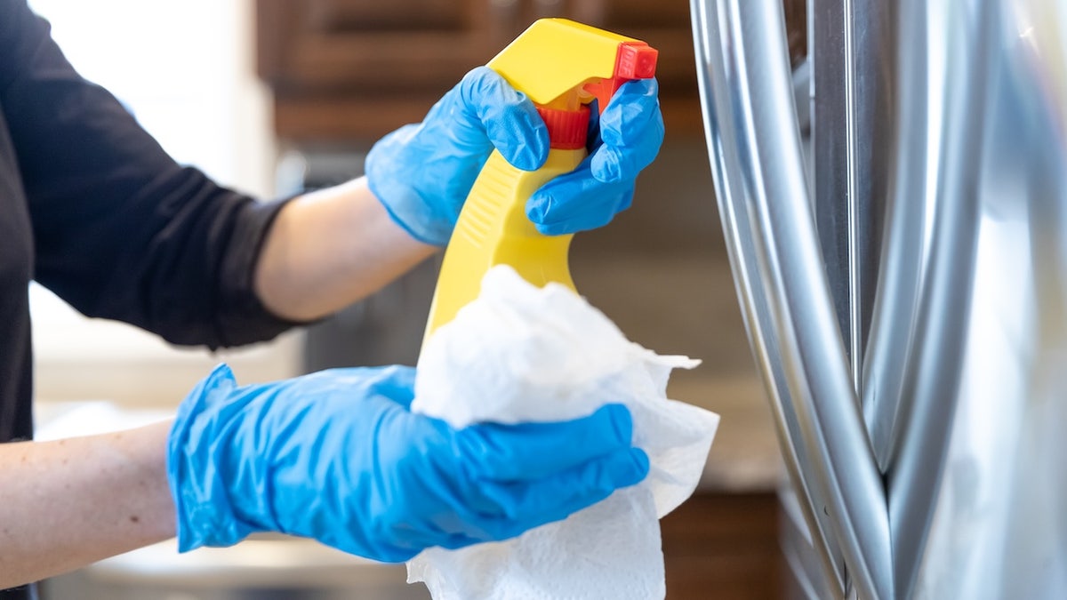 Woman cleaning stainless steel